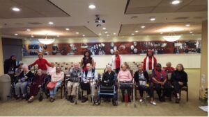 A group of people sitting in chairs and posing for the camera.