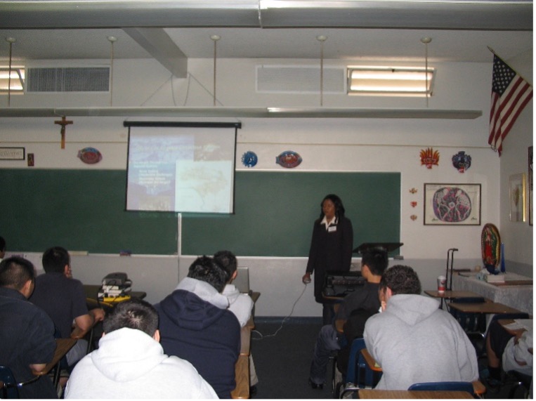 A woman standing in front of a class room